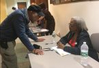 Carol Anderson signs copies of her book and talks about elections with attendees after her discussion at the Public Library of Brookline. Sept. 11. Photo by Noor Adatia / BU News Service.