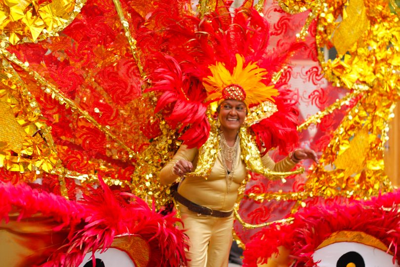 Member of the Caribbean Carnival Association displays her costume at the Columbus Day Parade in East Boston, on Sunday, Oct. 7. Photo by Flaviana Sandoval / BU News Service