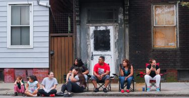 Families gathered on along Chelsea Street to watch the Columbus Day Parade in East Boston, on Sunday, Oct. 7. Photo by Flaviana Sandoval / BU News Service