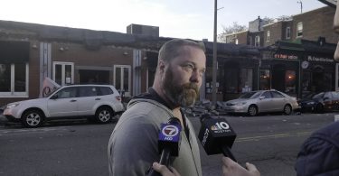 Bob O’Guin, owner of the Common Ground Bar & Grill, addresses the media after a partial roof collapse at Common Ground Bar & Grill in Allston, Nov. 4. Photo by Aaron Ye / BU News Service.