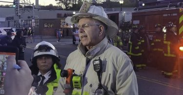 Deputy Fire Chief, Stephen Miller, addresses the media after a partial roof collapse at Common Ground Bar & Grill in Allston, Nov. 4. Photo by Aaron Ye / BU News Service.